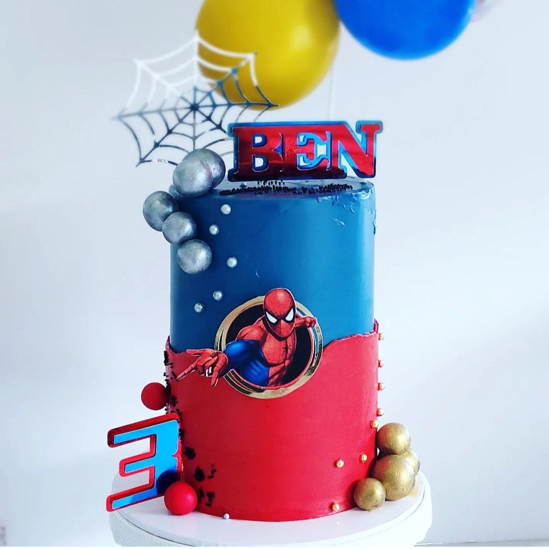 Red and blue superhero cake with the name Ben and the number 3